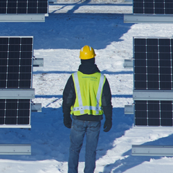 consumers energy worker with solar panels